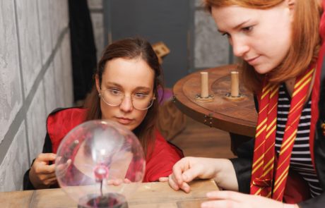 two girls looking at a electric magic round glass